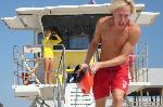 A lifeguard rushes to help a swimmer