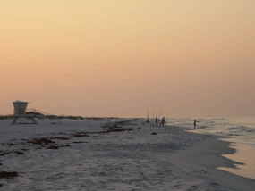 Sunrise with fishermen on beach at Langdon Beach Area