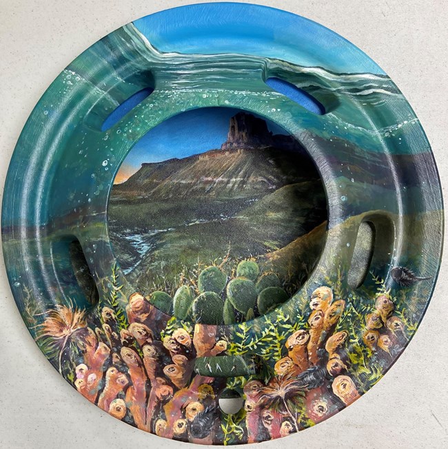 A found hubcap painted with a scene of the Permian Age sea