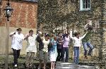 students jump off stone wall