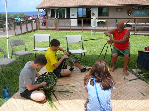 Bolly Helekahi teaching coconut weaving.