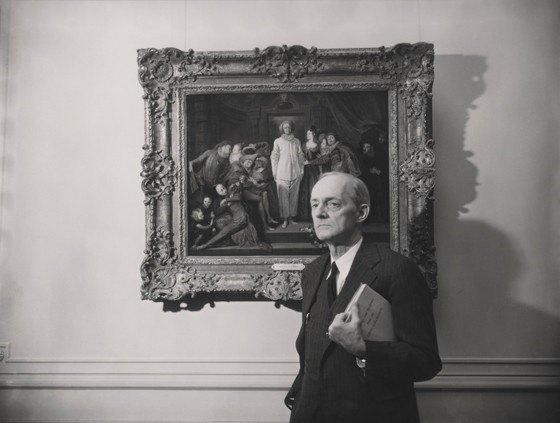 black and white photo of David Finley in front of a painting.
