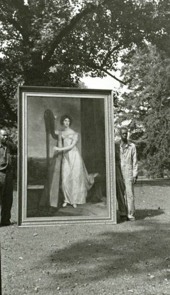 Thomas Sully's painting being held on the front lawn by to laborers as it is about to be transported to the National Gallery of Art.