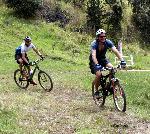 2 bike riders make a turn