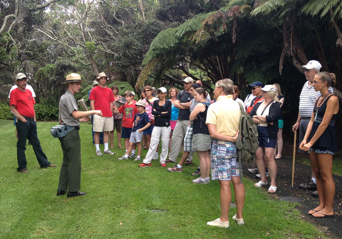 Ranger Travis and visitors explore the summit rainforest on Kīlauea volcano