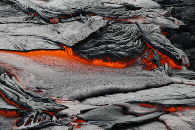 Pahoehoe lava breaks out of the crust and reveals its white hot interior