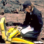 A volunteer installs a gps monitor on Mauna Loa