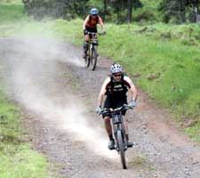 Mountain bike riders kick up alot of dust on the downhill