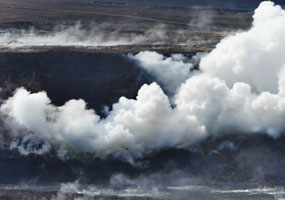 Gasses jet out of rubble on the crater wall of Halema`uma`u