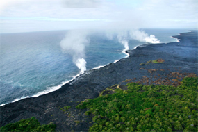 Lava flows into the ocean producing 3 steam plume