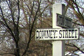 A painted wooden sign marks the intersection of Downey and Penn Streets.