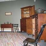 Rocking chair and other wooden furnishings from the Birthplace Cottage on display in the Visitor Center exhibit room.