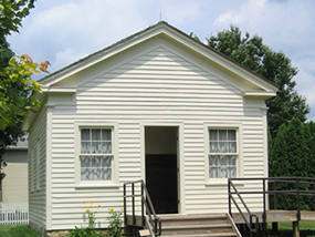White, one-story frame schoolhouse.