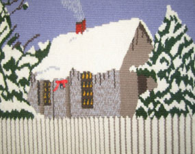 Hand-woven tapestry of a small wooden cottage behind a picket fence with a snow covered roof and flanked by snow-frosted trees. Hand-woven tapestry of a small wooden cottage behind a picket fence with a snow covered roof and flanked by snow-frosted trees.