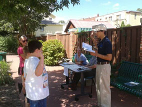 A park volunteer leads kids in the Junior Ranger pledge.