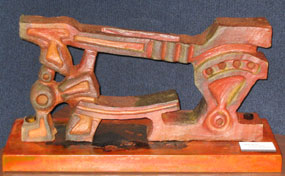 Orange ceramic sculpture of a floor-mounted iron cutting blacksmith tool. Orange ceramic sculpture of a floor-mounted iron cutting blacksmith tool.