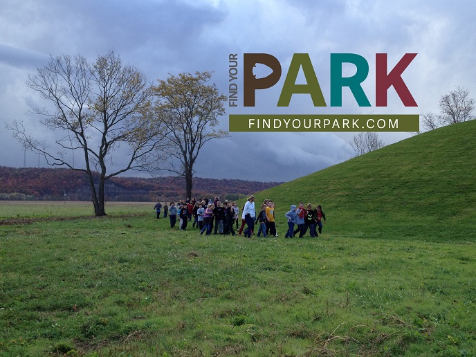 Students walk around Seip Mound with the Find Your Park logo atop the photo.