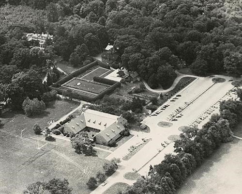 Aerial photograph of a large estate with buildings and a large parking lot.