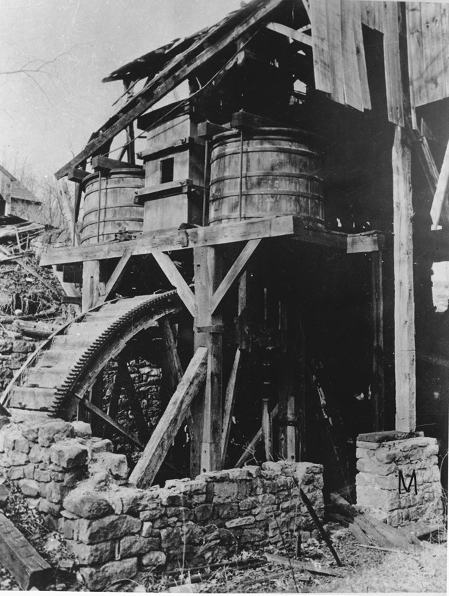 Historic water wheel powers blast machinery.