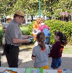 Ranger showing booklet to children