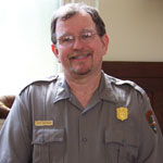 Portrait of ranger in uniform: Brown haired white male with a mustache