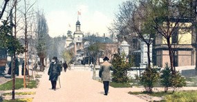 Tinted post card of Bathhouse Row in 1908 in the winter. Gentlemen stroll in front of the Palace Bathhouse with the Maurice Bathhouse on the right and the Arlington Hotel visible in the background. On left side of the sidewalk are the slender bare trunks of the Lombardy poplars with some Southern magnolia greenery visible, and on the right side are bare young elm tree trunks.
