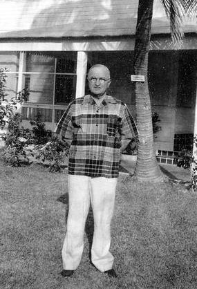 Snapshot of President Truman in plaid sport shirt, in yard at Key West.