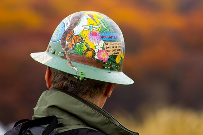 A Trail Volunteer wears a hard hat