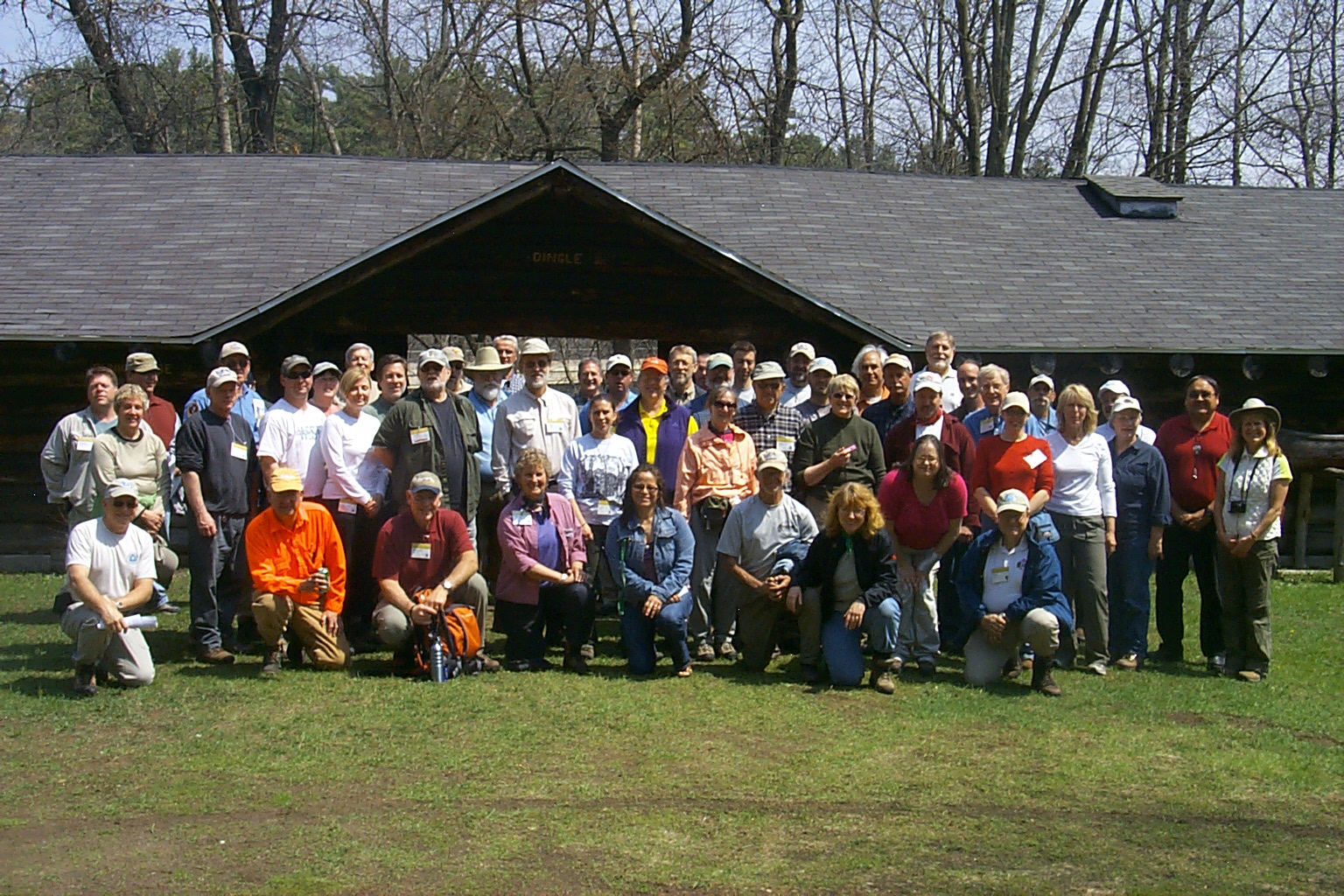 Participants gather fror a group photo in front of a building at the Menominee Logging Museum.