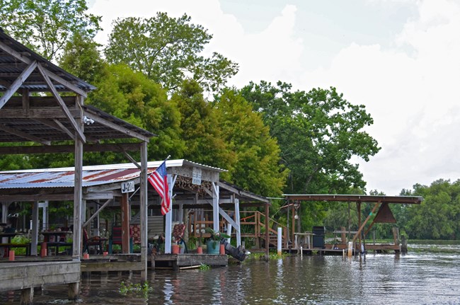 Wooden docks and camps along a canal bordering Jean Lafitte NHP&P