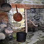 Historic stone hearth with pots