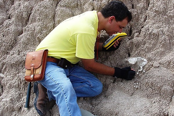 paleontologist documenting fossil in Badlands National Park