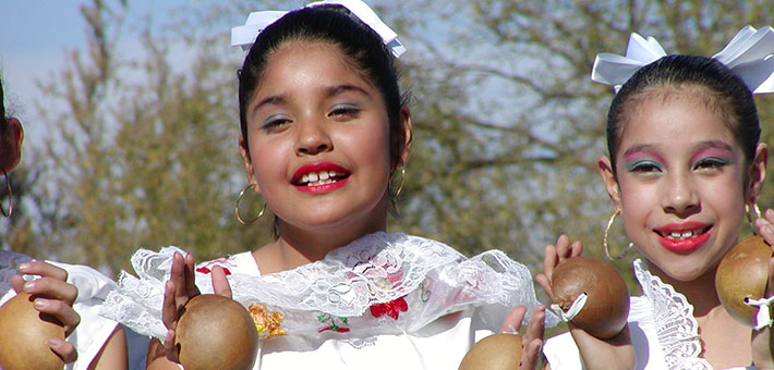 Latino girls dressed in traditional costume
