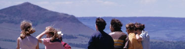 color photograph of children looking at mountain