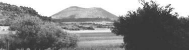 black and white photograph with Capulin Volcano in distance