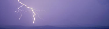 color photograph of lightning bolt over mesa