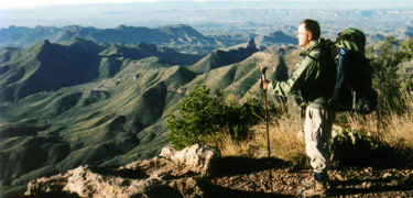 A hiker soaks in the view from the South Rim