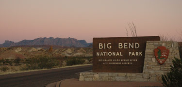 The west entrance sign at sunset