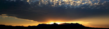 The setting sun behind the Chisos Mountains