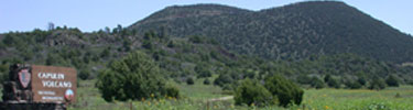 color photograph of Capulin Volcano with entrance sign in foreground