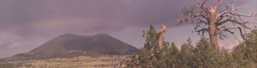 old faded color photograph of Capulin Volcano with rainbow