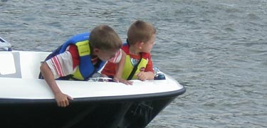 Boys in life jackets boating on the Lake of the Arbuckles