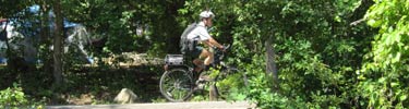 Park ranger on bike patrol along Travertine Creek