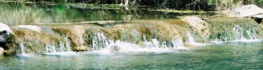 Clear water cascading over a small waterfall