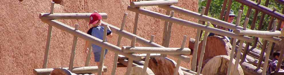 Small boy climbs on wooden caretta