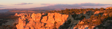 The sunset turns the cliffs red at Sandstone Bluffs