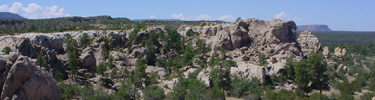 Sandstone cliffs rim the lava flows of El Malpais