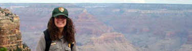 Park Aide standing by Grand Canyon.