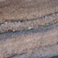  color photograph of several layers of ash of various colors