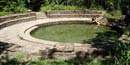 A circular stone enclosure around spring water
